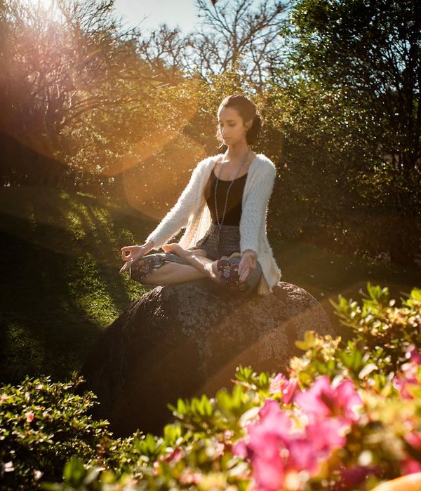 Woman in a calm yoga pose, embodying balance and tranquility.